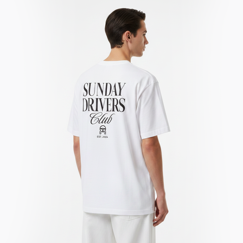 Person wearing a white t-shirt with 'Sunday Drivers Club' text on the back, standing against a plain background.