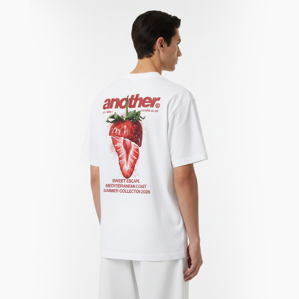 Person wearing a white t-shirt with a strawberry graphic and text on the back.