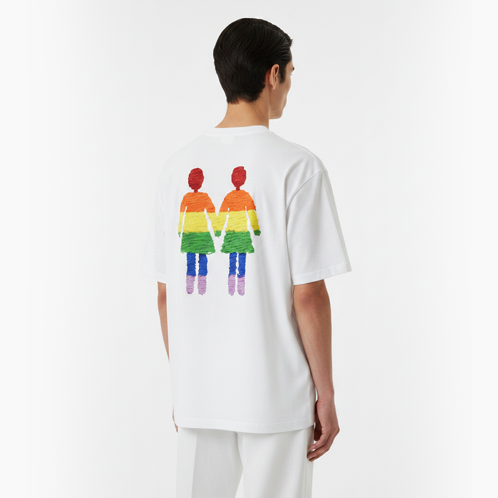 Person wearing a white t-shirt with a colorful graphic of two people on the back, standing against a white background.
