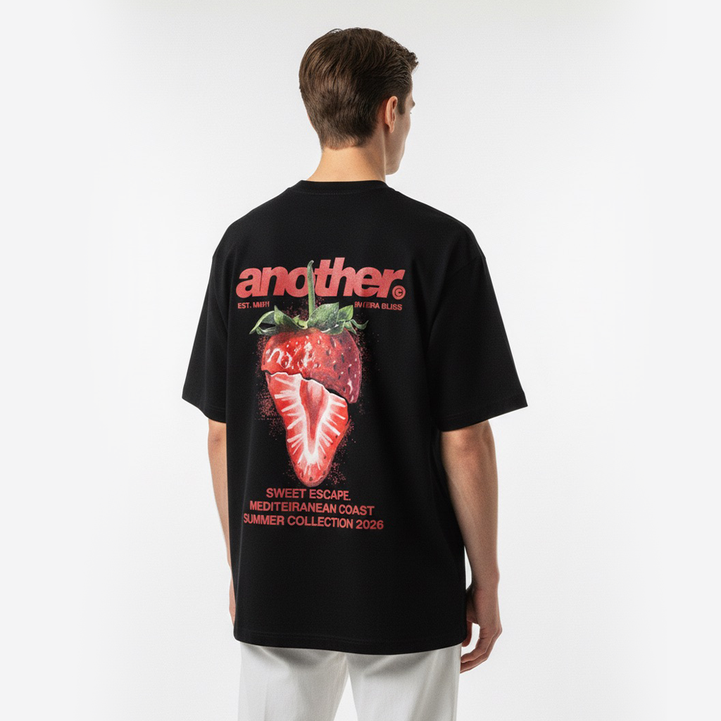 Person wearing a white t-shirt with a strawberry graphic and text on the back.