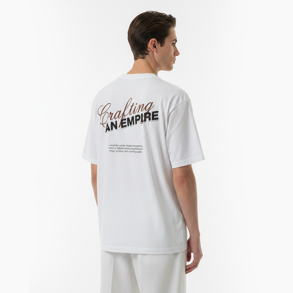 Person wearing a white t-shirt with text on the back, standing against a plain background