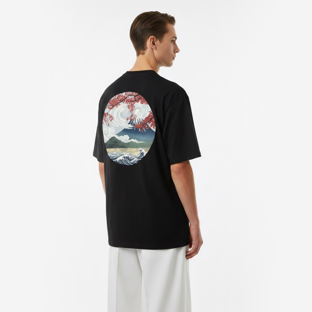 Person wearing a white t-shirt with a colorful graphic on the back against a plain background