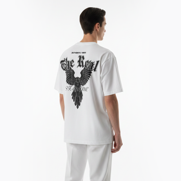 Person wearing a white t-shirt with black eagle design on the back against a white background