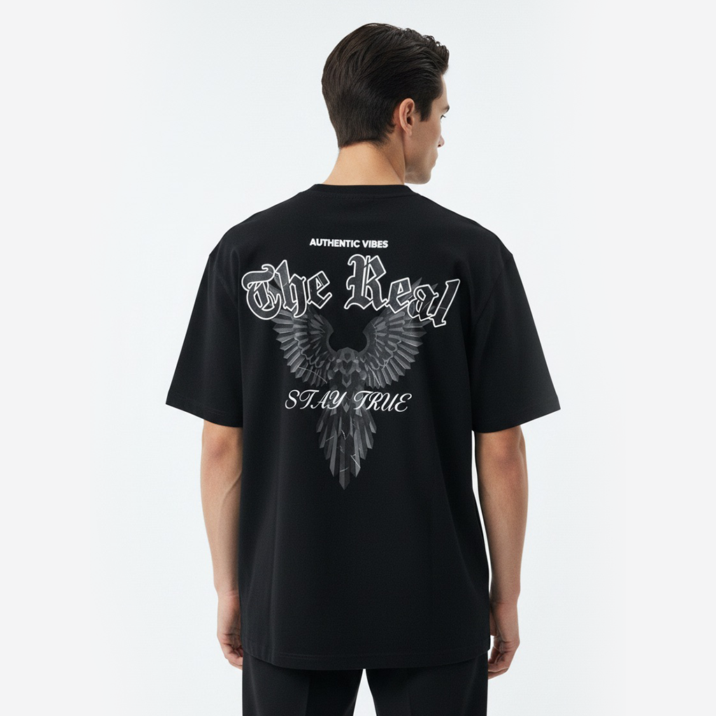 Person wearing a white t-shirt with black eagle design on the back against a white background