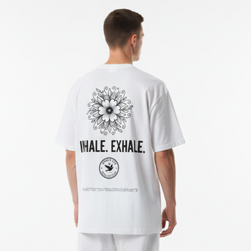 Person wearing a white t-shirt with a floral design and text on the back against a white background