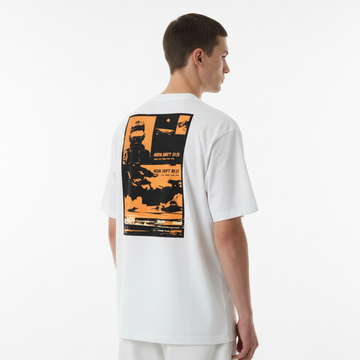 Person wearing a white t-shirt with an orange and black graphic on the back against a white background