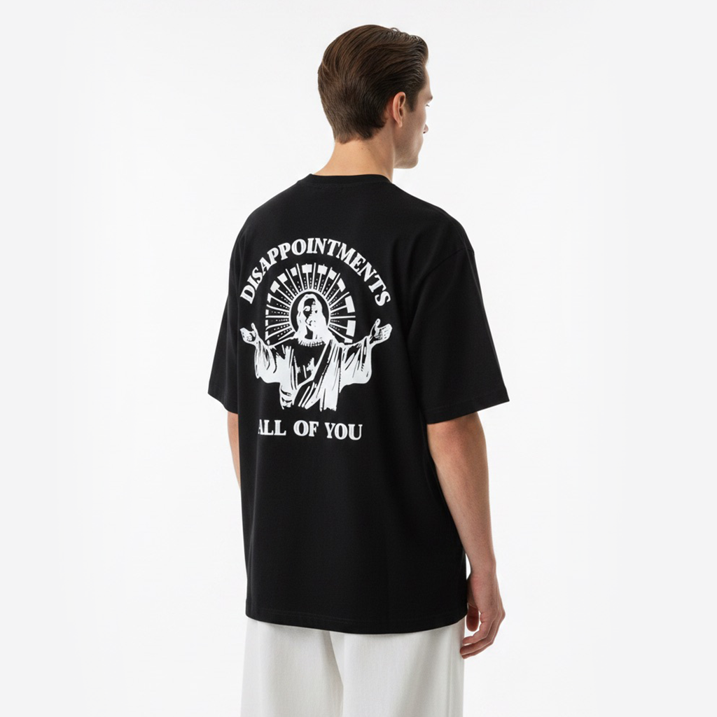 Person wearing a white t-shirt with a graphic design on the back against a white background