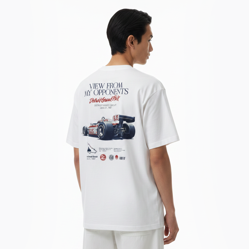 Person wearing a white t-shirt with a racing car graphic and text on the back