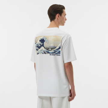 Person wearing a white t-shirt with a graphic design on the back, standing against a plain background