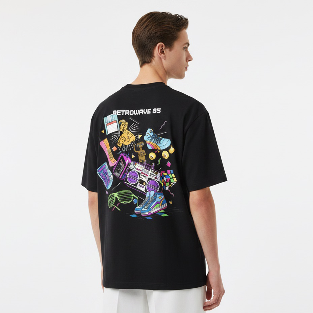 Person wearing a white t-shirt with colorful graphic design on the back, standing against a plain background.