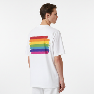 Person wearing a white t-shirt with a rainbow design on the back against a white background