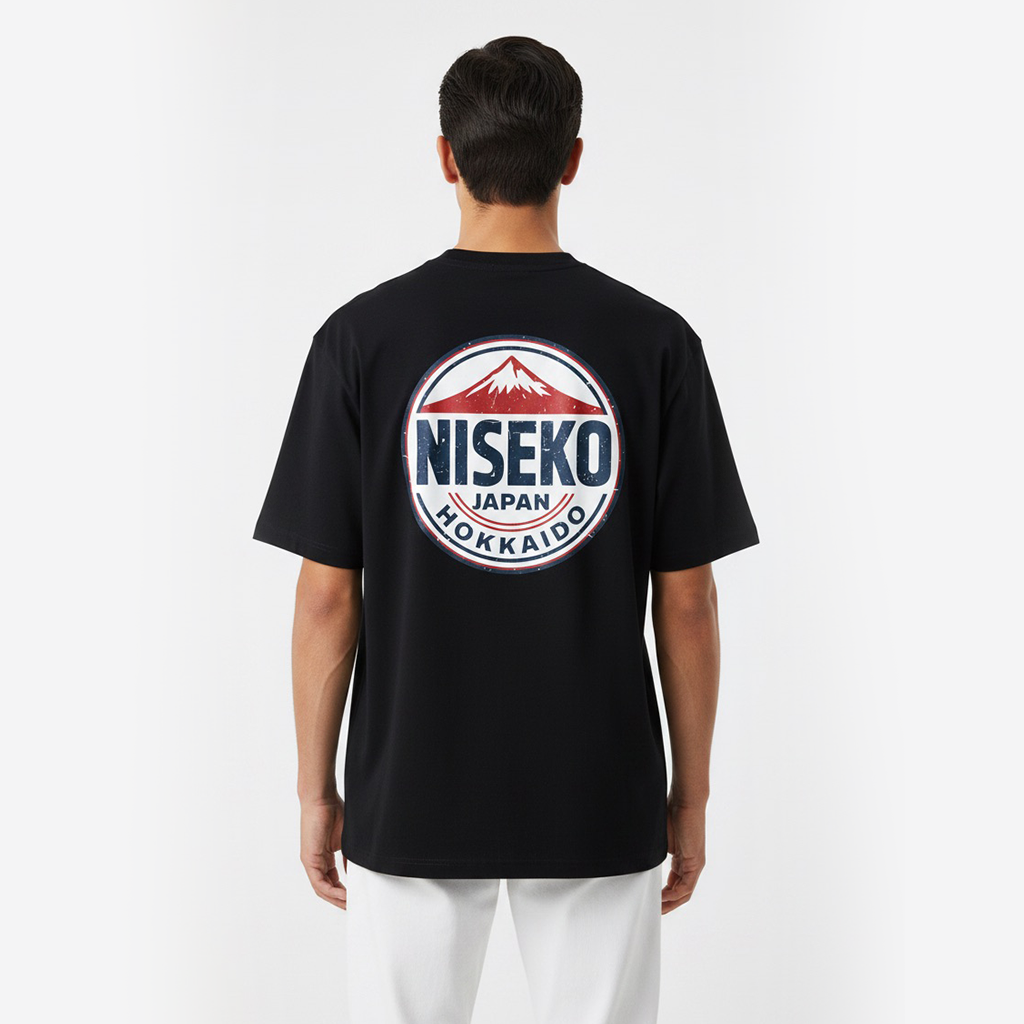 Person wearing a white t-shirt with a Niseko logo on the back against a white background